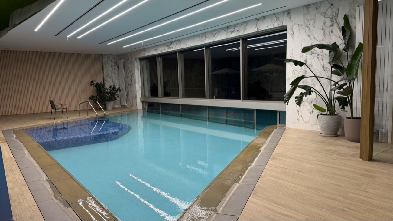 Pool hall with a full-height glazed wall