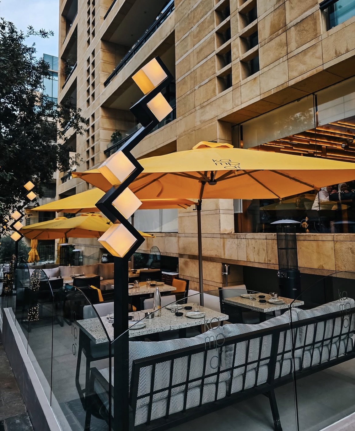 The terrace under its parasols at dusk