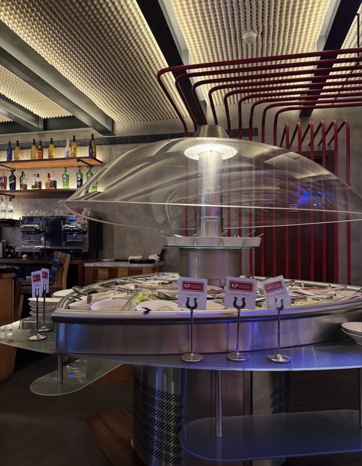 The buffet counter beneath its glass dome