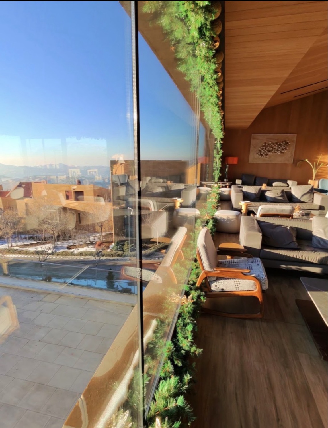 The lounge behind its frameless glazing