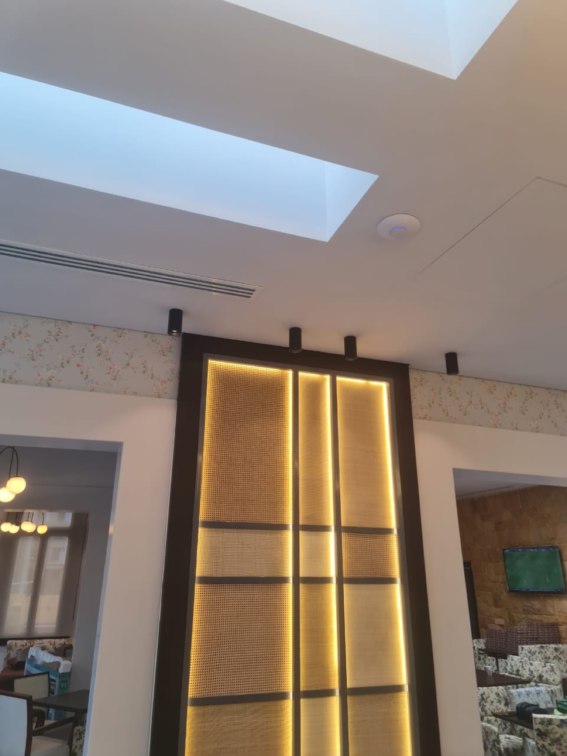 A backlit cane panel set into its dark frame