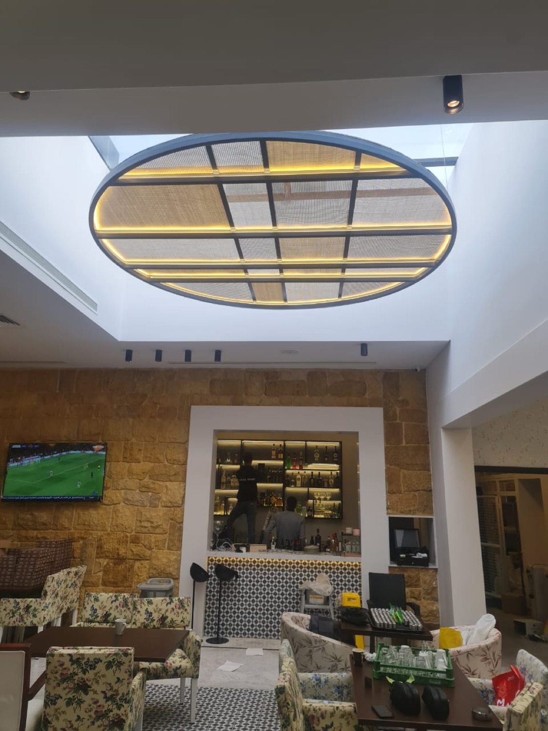 The oval ceiling feature, lit from behind its mesh