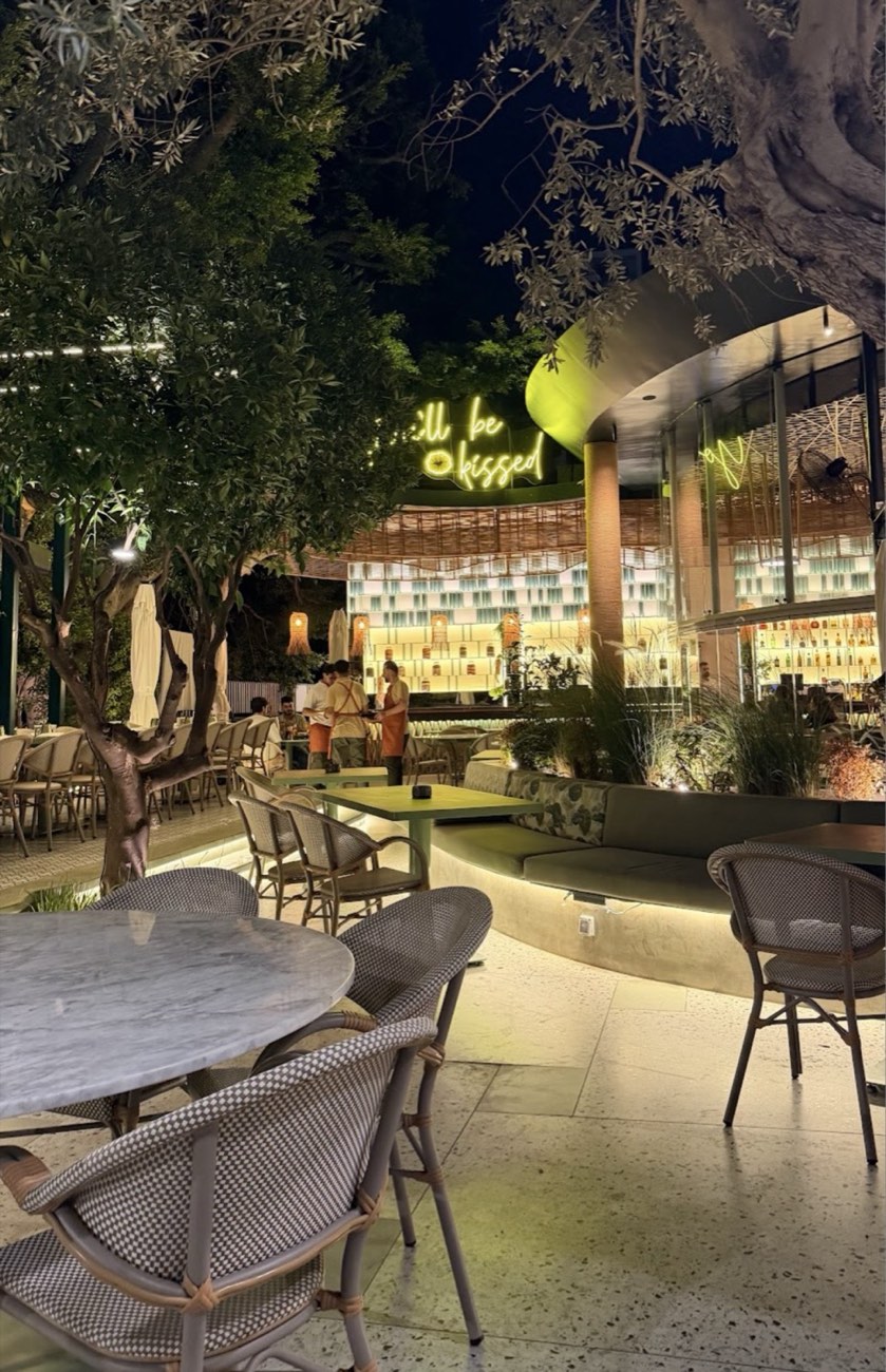 Garden restaurant lit at dusk