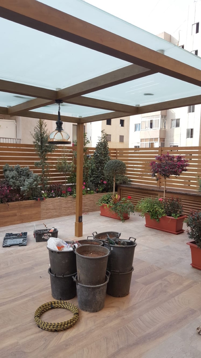 Glass roof panels laid between timber beams, over a courtyard
