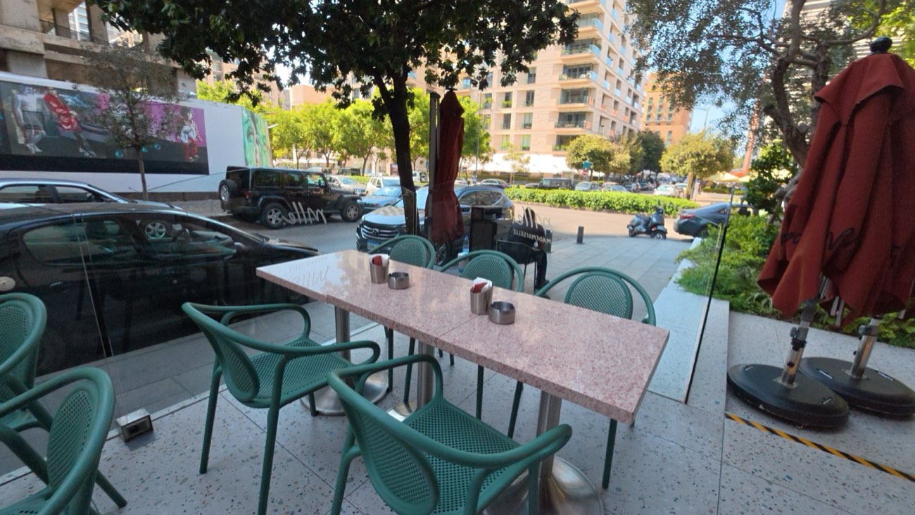 Terrace with parasols over a glazed frontage