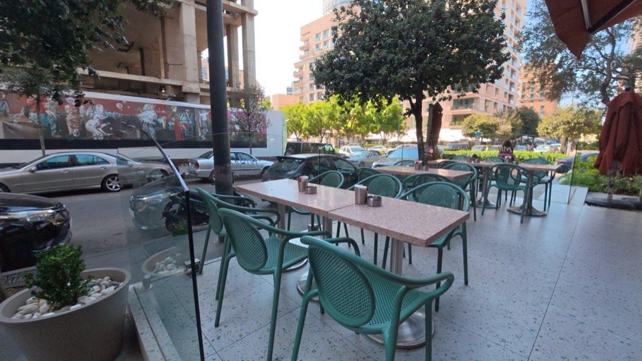 Café terrace behind curved glass wind screens