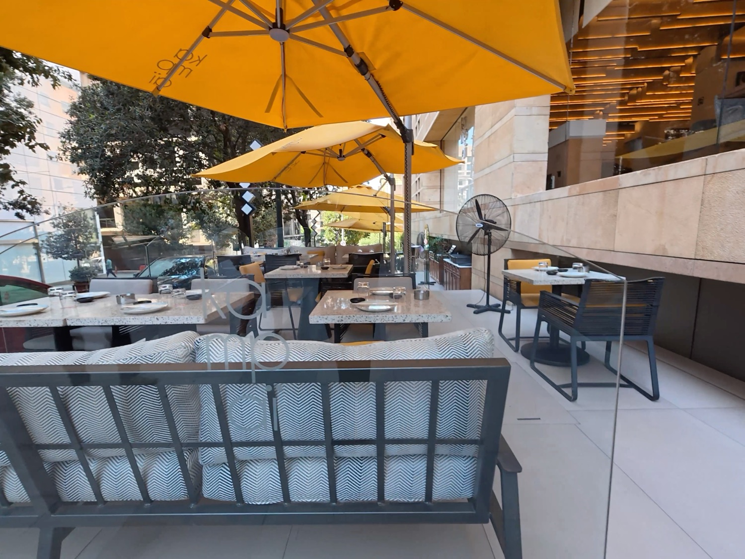Terrace enclosed by a frameless glass wind screen